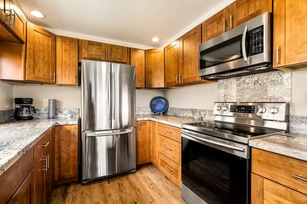 Modern stainless steel appliances including a spacious double-door refrigerator and stove setup