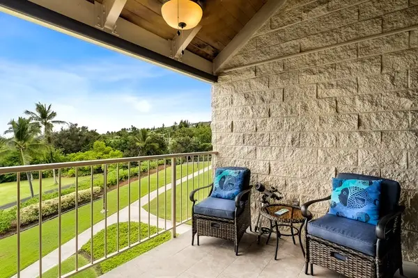 Unwind on the balcony featuring comfortable armchairs and sweeping tropical views