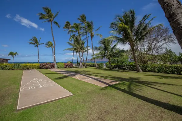 Menehune Shores Resort is your own tropical paradise.  Play shuffle board on Menehune Shores Resort property beneath the swaying palm trees.