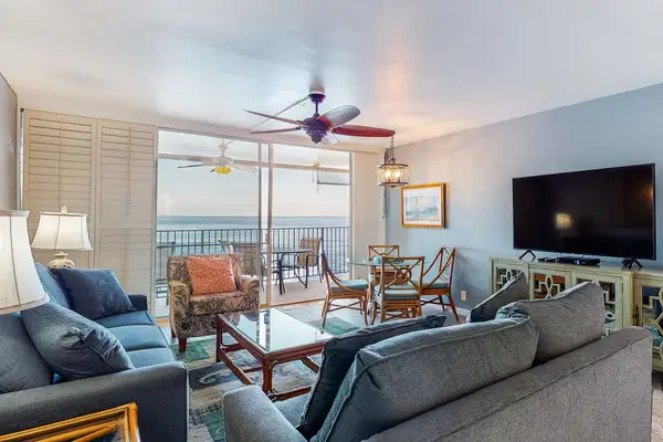 Living room with sleeper sofa, flat screen tv and views of the lanai.