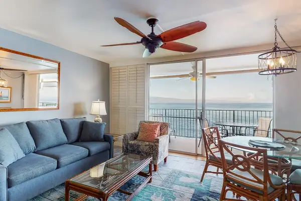 Living room with sleeper sofa, flat screen tv and views of the lanai.