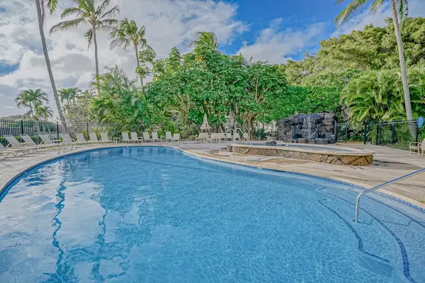 Sparkling Resort Pool Surrounded By Palms