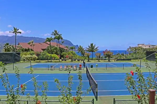 Enjoy a friendly tennis match beneath beautiful sunny island skies