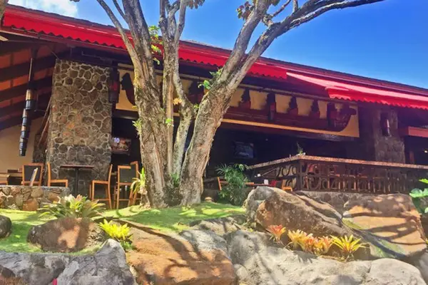 Welcoming resort entrance showcases warm island charm and natural surroundings