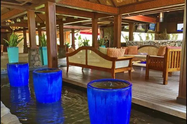 Wooden pavilion offers comfortable seating, colorful accents, and open-air relaxation