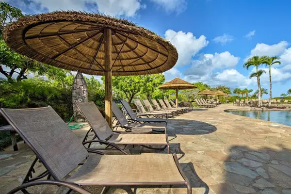 Comfortable seating by the pool with scenic views and blue skies