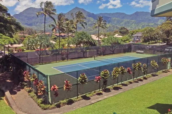 Tennis court offers an outdoor setting surrounded by mountain scenery