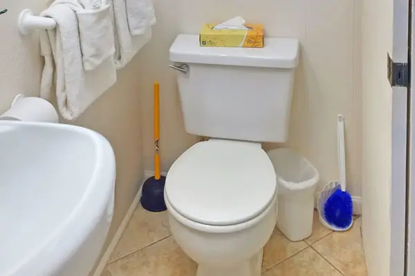 Clean full bathroom stocked with essential amenities.