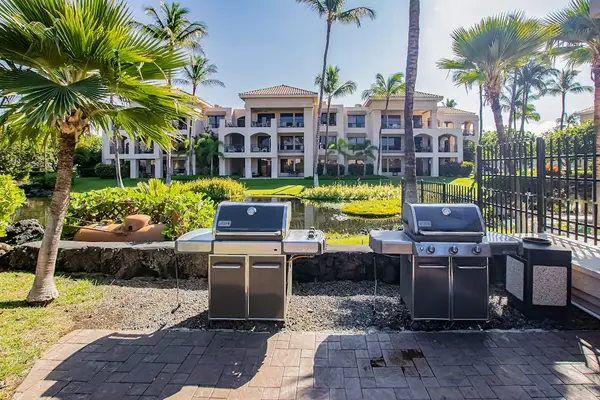 Outdoor Stainless Steel BBQ Grilling Station Set Against Scenic Water View