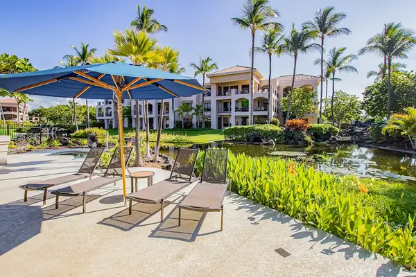 Pondside Pool Deck Area Outfitted with Sun Chairs & Shade Umbrellas
