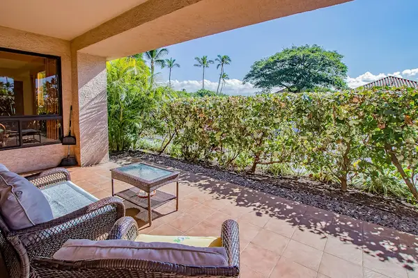 Covered Outdoor Living Space Facing Lush Garden Hedges & Tropical Palms
