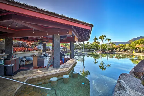 Enjoy relaxing poolside moments from this shaded tropical gathering area