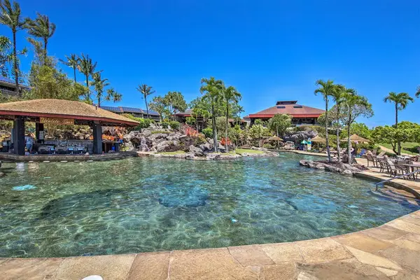 Cool off in the sparkling pool surrounded by tropical scenery