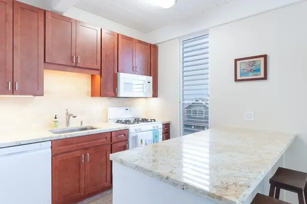 Countertop Prep Space, Wood Cabinetry, Microwave, Sink & Stove