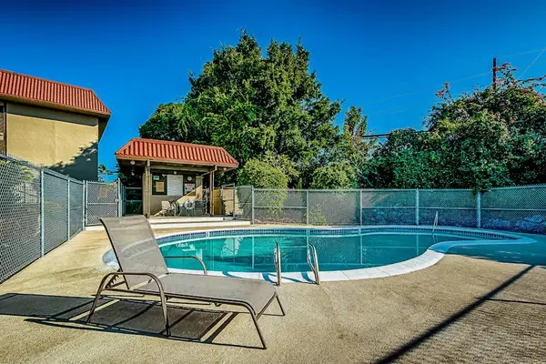 Poolside Lounge Deck with Outdoor Swimming Pool and Fenced Enclosure
