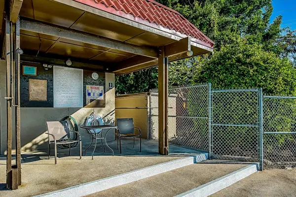 Backyard Covered Pavilion with Patio Seating and Information Board