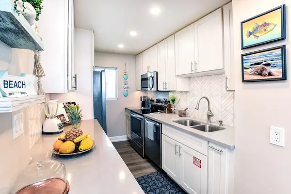 Modern stainless steel kitchen with an open-concept design that flows seamlessly into the living room, making it easy to cook, gather, and stay connected.