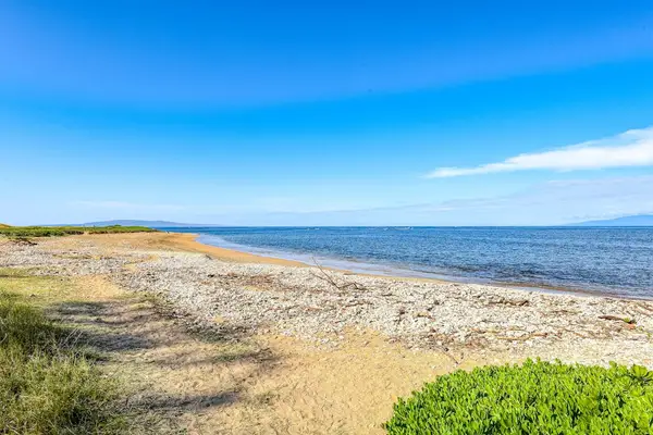 Crystal-clear turquoise waters gently wash onto pristine white sandy beaches.