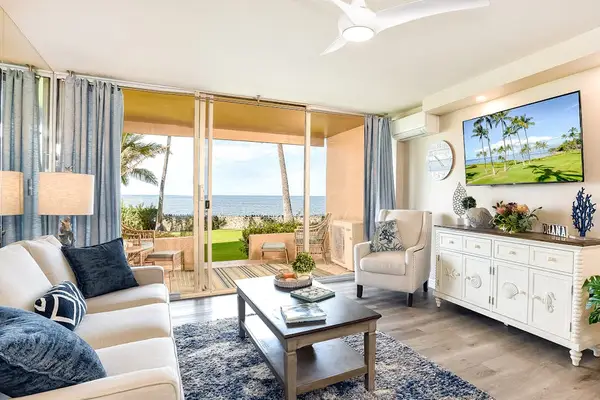 Bright living room with sliding glass doors, abundant natural light, flatscreen tv and a comfortable sofa bed for extra guests.