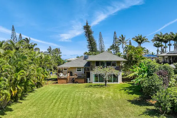 Relax in the spacious tropical backyard filled with fruit trees and blooming orchids. Kids can run and play while you enjoy the peaceful setting and beautiful ocean views from the back of the property.