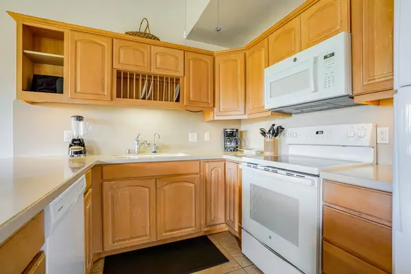 Bright Kitchen Layout with Built-In Plate Rack & Modern Appliances