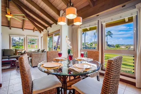 Glass Dining Setup featuring Vaulted Wood Ceilings & Island Views