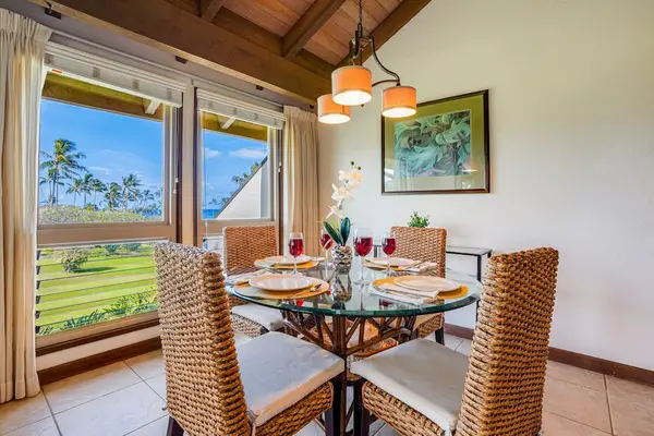 Scenic Dining Nook with Large Windows Overlooking Lush Greenery