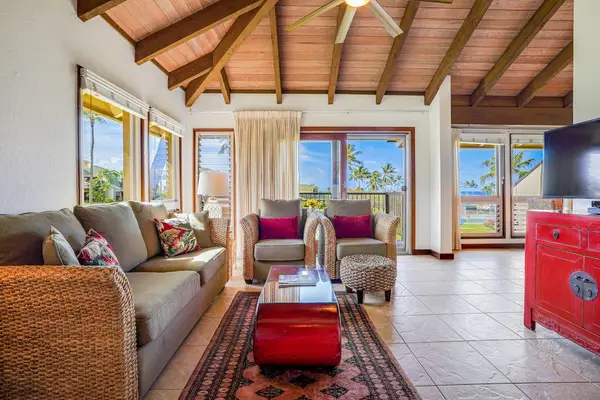Spacious Living Room Setup Showcasing Vaulted Ceilings & Natural Light