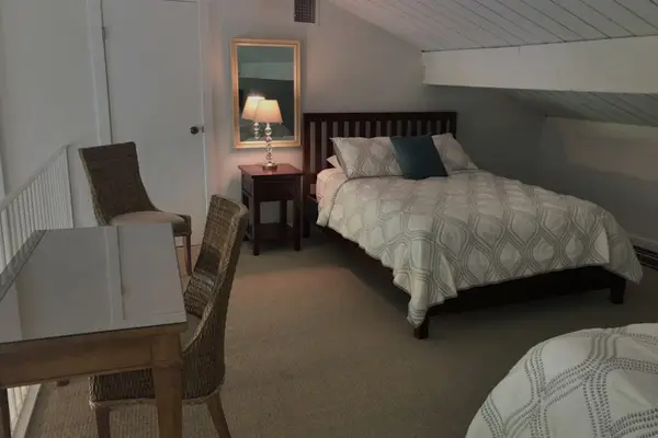 Cozy loft offers bedside table, seating, and restful sleeping space