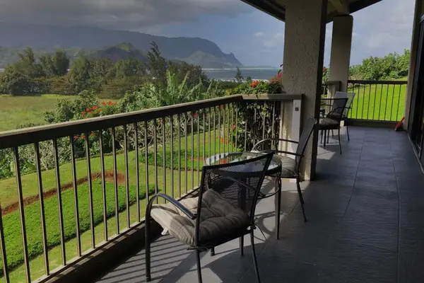 Covered balcony offers seating, garden views, and peaceful outdoor relaxation