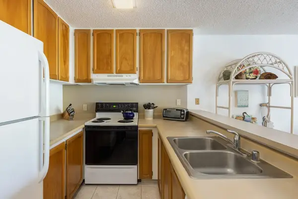 Full Kitchen Overview – Fridge, Stove & Sink