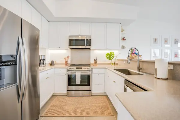 Modern kitchen with updated stainless steel appliances, spacious countertops, and ample cabinet storage