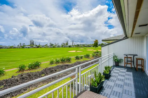 Private ground-floor lanai overlooking lush golf course greens and tropical views