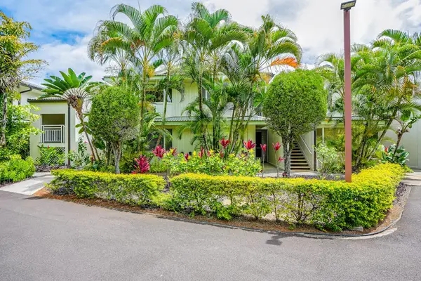 Charming tropical exterior surrounded by manicured gardens and swaying palm trees
