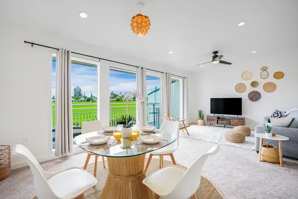 Bright, open-concept living area featuring comfortable seating and a dining space filled with natural light