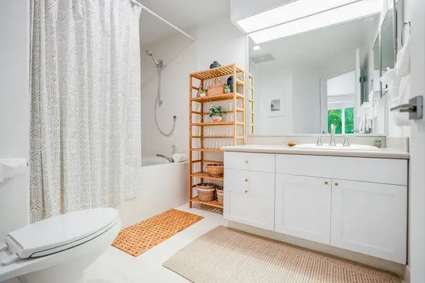 Bright, updated bathroom with modern vanity and shower/tub combo