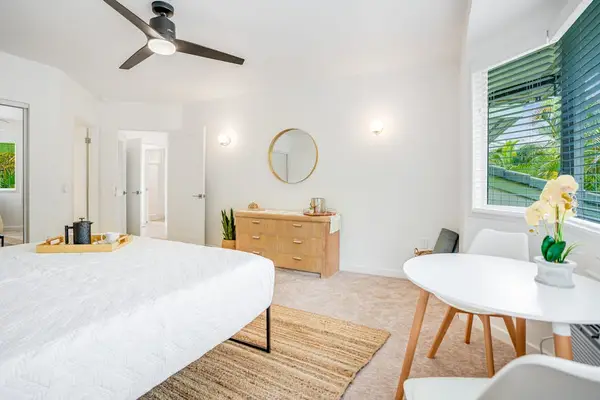 Cozy seating corner in the primary bedroom with peaceful garden views