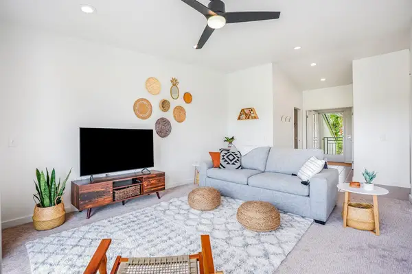 Cozy seating area with flat-screen TV and boho-inspired tropical decor