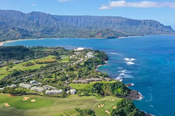 Stunning aerial view of the lush Princeville coastline and ocean backdrop