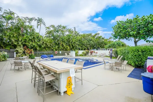 Shaded poolside dining area, perfect for enjoying outdoor meals and social gatherings