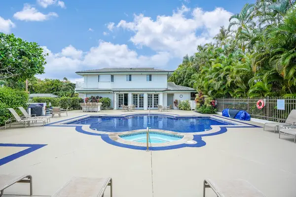 On-site swimming pool surrounded by tropical landscaping, perfect for relaxing in the sun