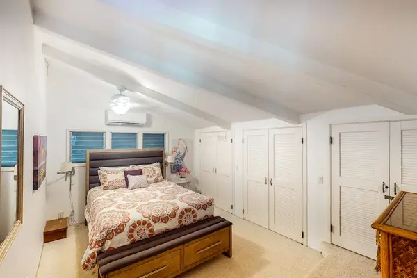 Cozy queen bedroom with warm, inviting decor for a restful night's sleep