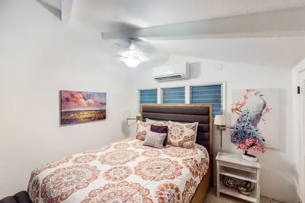 Comfortable queen suite with modern furnishings and plenty of storage