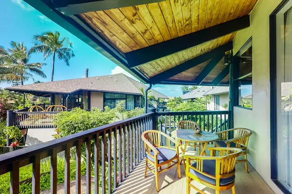 Relax on the covered lanai with tropical garden views