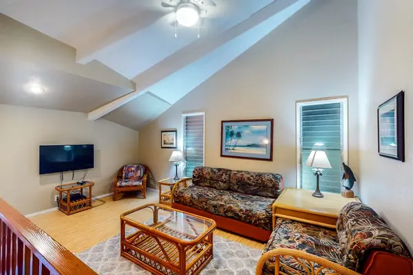 Stylish living space with tropical decor and sofa beds for extra guests