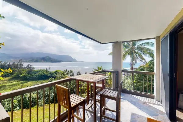 Covered balcony offers dining seating, mountain vistas, and tropical breezes