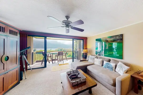 Bright living room features ocean views, comfortable seating, and television