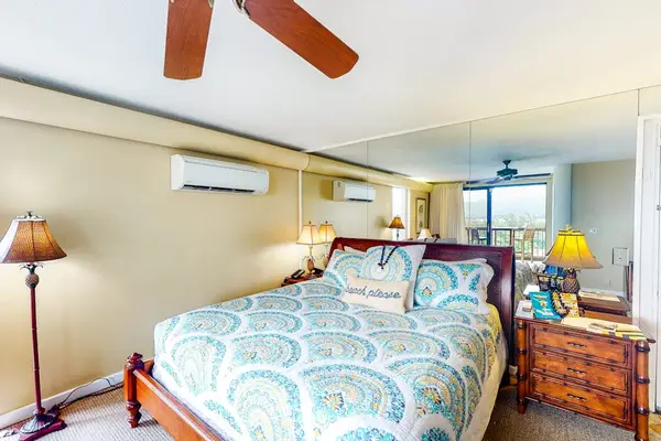 Studio  features patterned bedding, ceiling fan, and convenient air conditioning