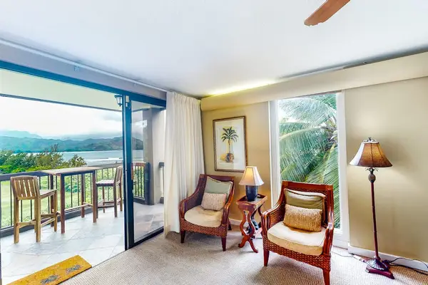 Living room offers ocean views, comfortable chairs, and natural light