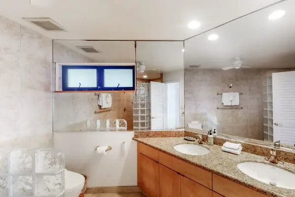 Contemporary bathroom features tiled walls, modern fixtures, and vanity storage